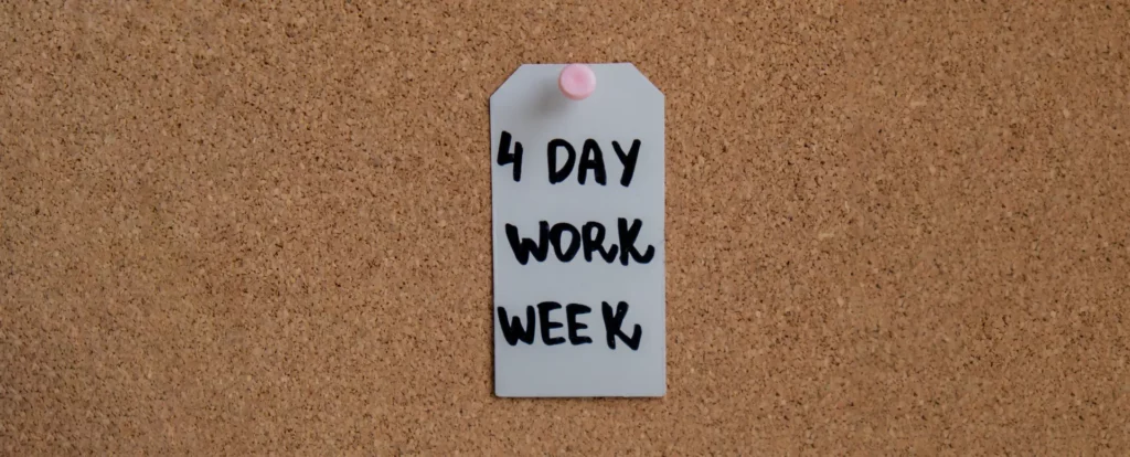 Cork board with a note pinned that says 4 day work week